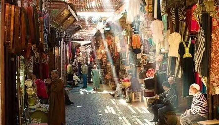 A lively scene of haggling in a Marrakech market, showcasing local trade culture.