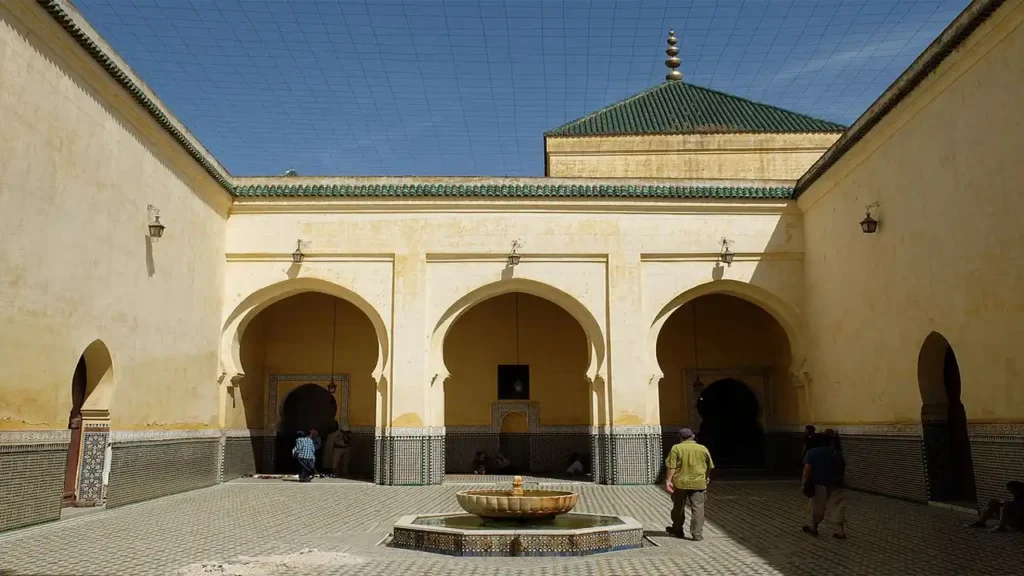 Exterior view of the Mausoleum of Moulay Ismail in Meknes, showcasing its historic Moroccan architectural design.