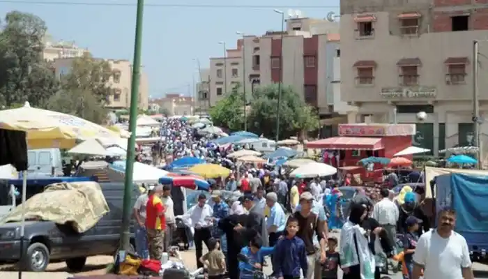 Souk El Had in Meknes, a lively weekly market with stalls displaying seasonal produce, artisanal crafts, and traditional Moroccan goods, capturing the vibrant local culture.