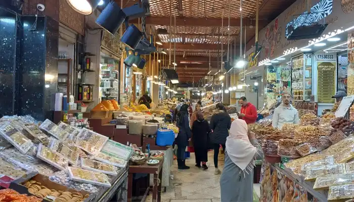 The vibrant Souk Lahdim in Meknes, featuring stalls brimming with fresh produce, aromatic spices, and local goods, capturing the lively essence of Moroccan market life.