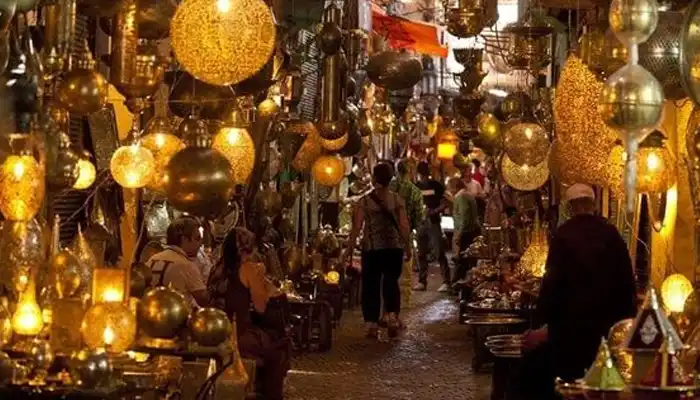 Bustling Souk Semmarine in Marrakech, lined with vibrant shops selling traditional goods and souvenirs.