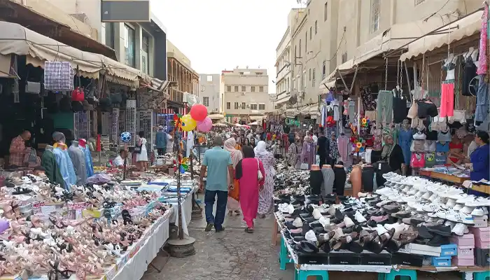 Stalls at Souk Sekkakine in Meknes showcasing intricately crafted metal goods, including brass teapots, trays, and traditional Moroccan items, highlighting the souk’s artisanal heritage.