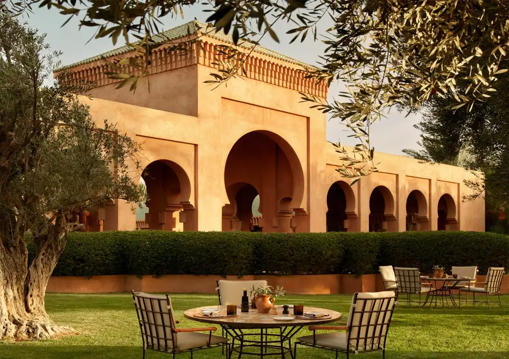 Elegant Amanjena hotel pavilion surrounded by serene gardens in Marrakech.