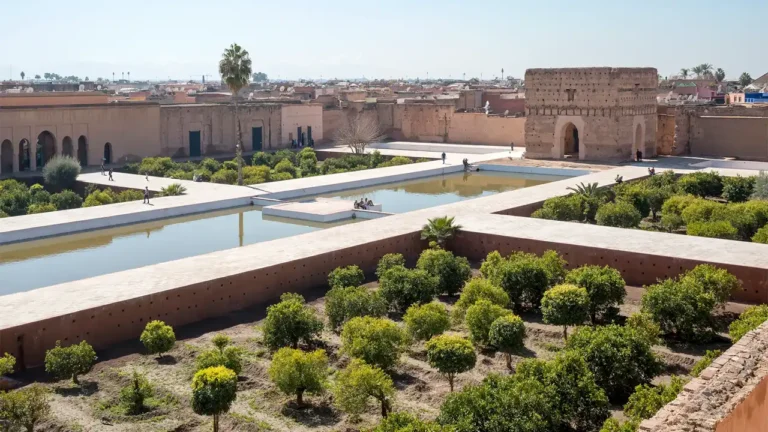 A wide view of El Badi Palace’s grand courtyard featuring reflecting pools and towering walls in Marrakech, Morocco.