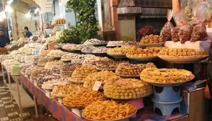 Plate of traditional Moroccan food in Meknes, featuring tagine, couscous, and vibrant spices.